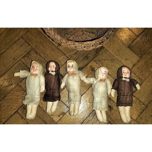 519 - ± Mr Neville's Toyshop Group of five dolls in a basket Five small soft faced dolls early C20th each ... 