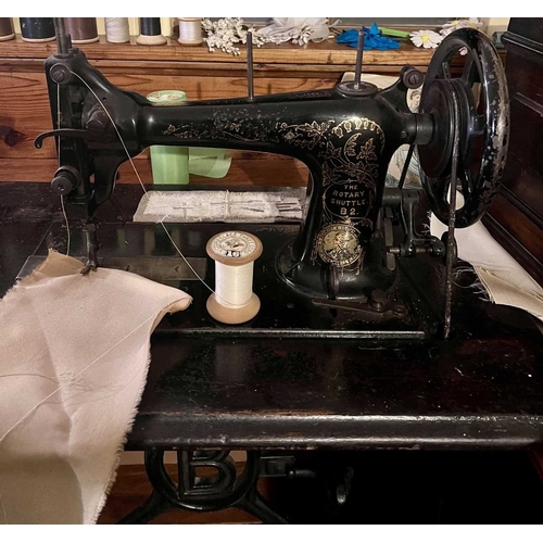 564 - ± K Fillingham Milliners Workshop Four Sewing Machines A Willcox and Gibbs treadle machine with lid,... 