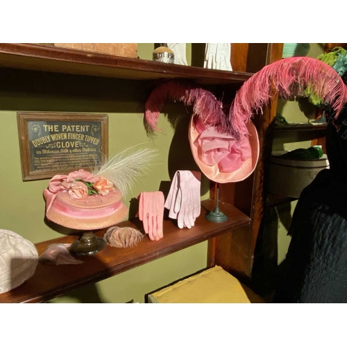 588 - ± K Fillingham Milliners Shop stock, hats, gloves etc Contents of central arched display behind coun... 