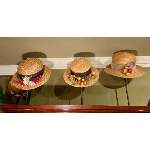 591 - ± K Fillingham Milliners Trimmed straw hats Seven trimmed straw hats above the top of the rear count... 