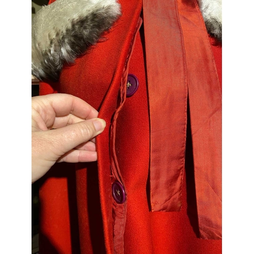 595 - ± K Fillingham Milliners Wool cape & mannequin In left hand shop window display, a red wool felt cap... 