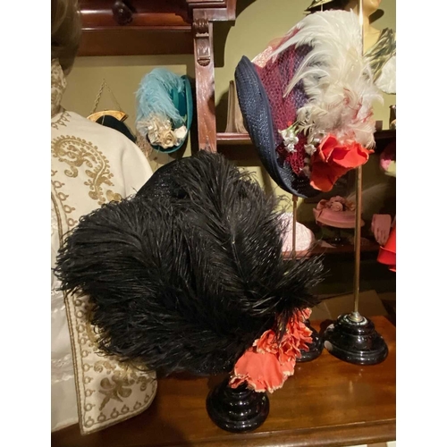 596 - ± K Fillingham Milliners Hats & stands In left hand shop window display: Three feather trimmed hats ... 