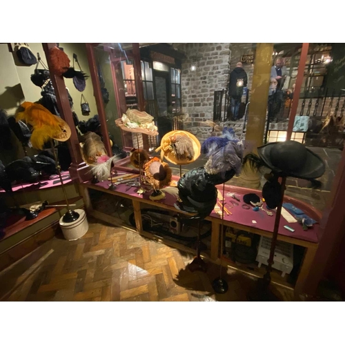 599 - ± K Fillingham Milliners Twelve feather trimmed hats and eleven display stands The twelve feather tr... 