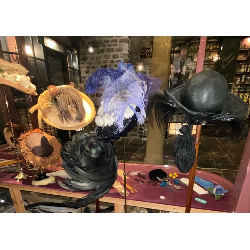 599 - ± K Fillingham Milliners Twelve feather trimmed hats and eleven display stands The twelve feather tr... 