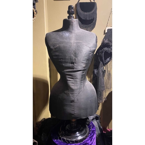 602 - ± K Fillingham Milliners Black fabric mannequin and cape A wasp waisted mannequin covered in black s... 