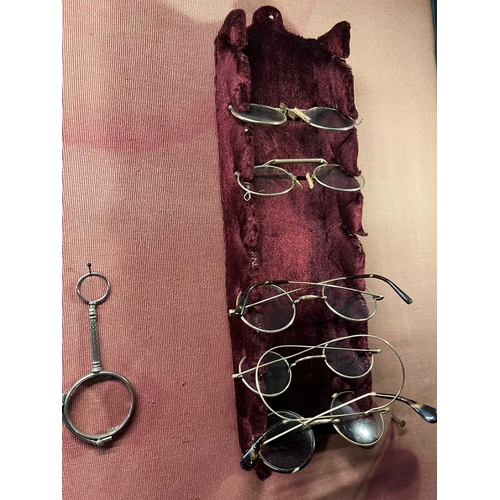 615 - ± Dotter's Jewellers & Opticians Optics A selection of ten antique spectacles on a pair of velvet-co... 