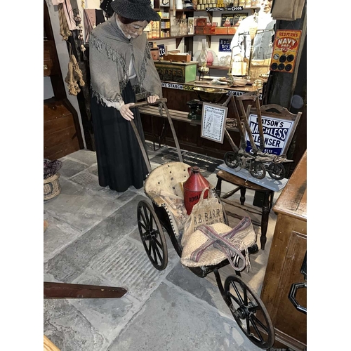 633 - ± Lugg's Hardware Store Display Tableaux A Victorian three-wheeled pushchair is filled with kindling... 