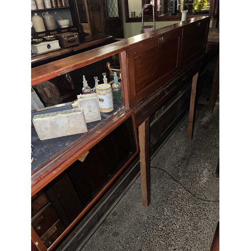 728 - ± J Dyke Apothecary A countertop cabinet Mahogany framed with curved glass and three mirrored doors ... 