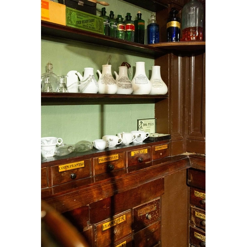 730 - ± J Dyke Apothecary The Apothecary's shop fittings with numerous drug drawers The impressesive fitti... 