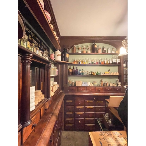 730 - ± J Dyke Apothecary The Apothecary's shop fittings with numerous drug drawers The impressesive fitti... 