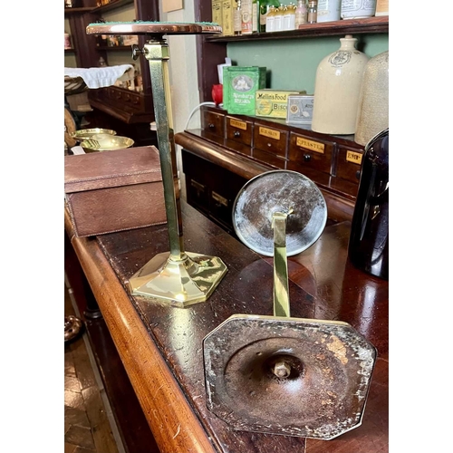 732 - ± J Dyke Apothecary Stands A pair of adjustable brass stands with iron-weighted bases 78cm maximum -... 