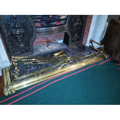 804 - ± Flambards Hotel Reception An Art Nouveau brass fender WxD 136x38cm and a set of three brass fire i... 