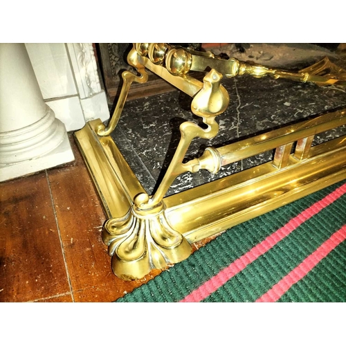 804 - ± Flambards Hotel Reception An Art Nouveau brass fender WxD 136x38cm and a set of three brass fire i... 