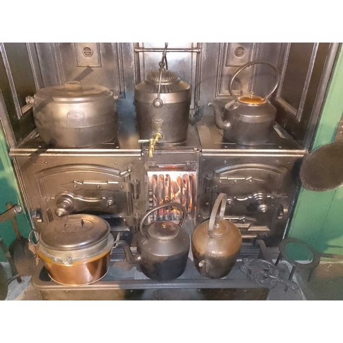 820 - ± Flambards Hotel Kitchen Cast-iron kitchen pots and pans etc. Including a four-gallon pot made by C... 