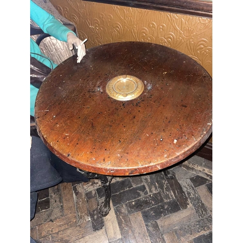 872 - ± Britain in the Blitz Cat Iron Pub Table A cast iron three legged pub table with circular hardwood ... 