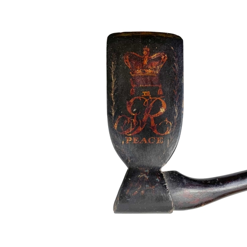 105 - A George III painted wood ceremonial axe. Painted with GR III monogram and the word 'Peace' beneath ... 