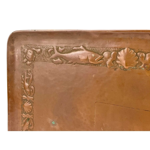 106 - A Newlyn copper rectangular tray. Repousse decorated with a border of fish, scallops and whelks, app... 