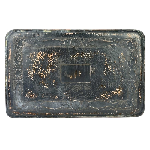 106 - A Newlyn copper rectangular tray. Repousse decorated with a border of fish, scallops and whelks, app... 