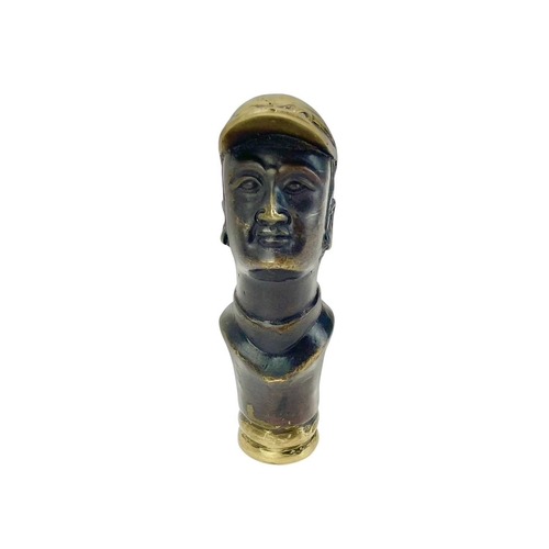 110 - A brass and lacquered brass cane handle, cast as a jockey. Thought to represent Fred Archer, height ... 