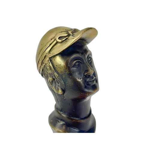 110 - A brass and lacquered brass cane handle, cast as a jockey. Thought to represent Fred Archer, height ... 