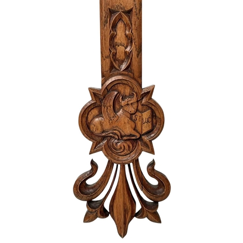 111 - A French carved oak wall mounted cross of fleur de lis form. Carved with 'IHS' to centre, surrounded... 