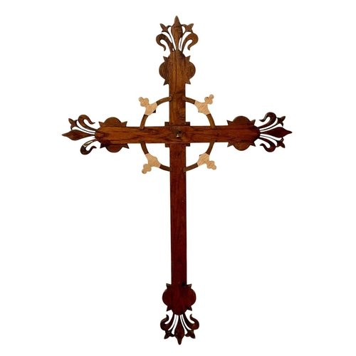 111 - A French carved oak wall mounted cross of fleur de lis form. Carved with 'IHS' to centre, surrounded... 