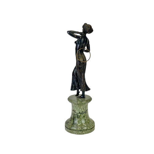 17 - Attributed to Gotthilf Jaeger (1871-1933) An Art Deco bronze figure of a dancer with a hoop, on a gr... 