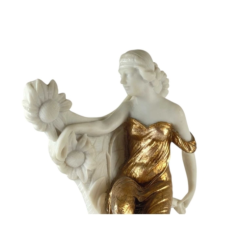 23 - An Art Nouveau style resin figure. The gilt robed maiden supporting a mirror, height 52cm.