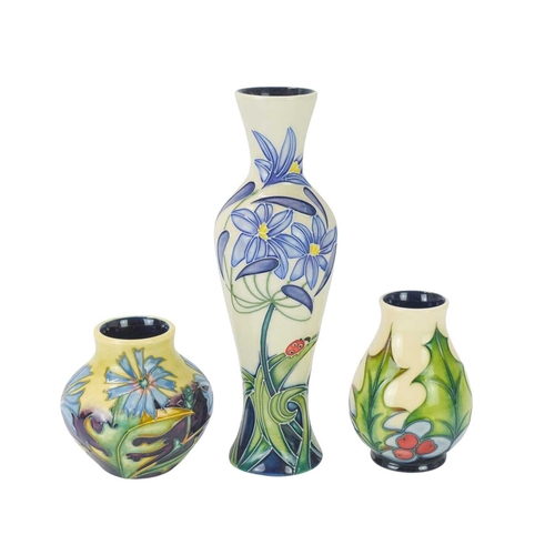 238 - Three Moorcroft vases in different forms. One 'Fly Away Home' vase, date stamp for 2006, height 21cm... 