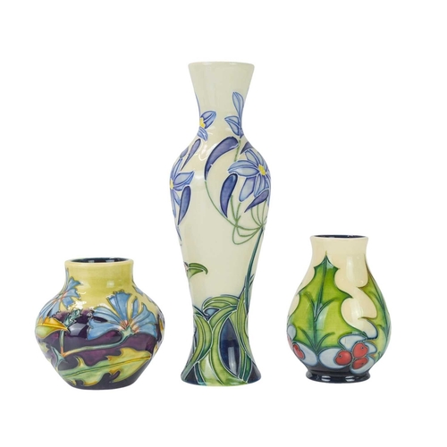 238 - Three Moorcroft vases in different forms. One 'Fly Away Home' vase, date stamp for 2006, height 21cm... 