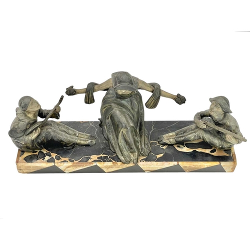 24 - A French Art Deco spelter Commedia dell'arte figure group. With a central Columbine being serenaded ... 