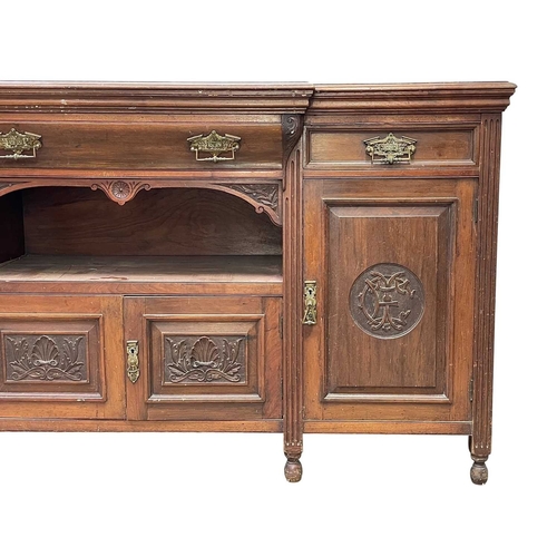 33 - Eastern Telegraph Company, A late Victorian walnut sideboard. Fitted with drawers and cupboards, the... 