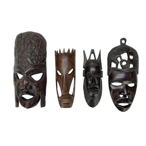 5 - Eight African carved hardwood masks. Length 40cm and smaller.