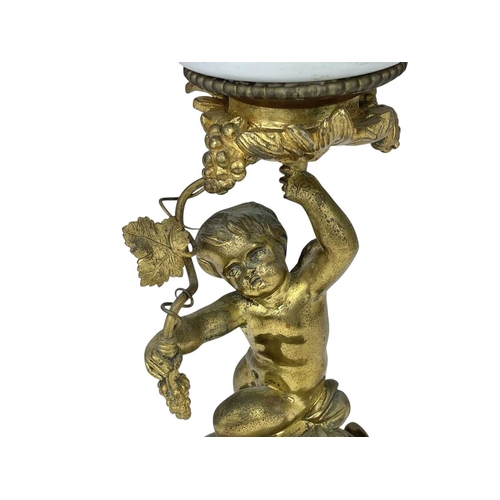 61 - A 19th century gilt brass cherub oil lamp. The opaque glass reservoir on a grape and vine base with ... 