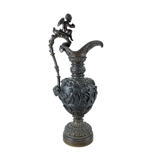 65 - A pair of substantial bronze side ewers. French, 19th century, the handles with cherub finials and r... 