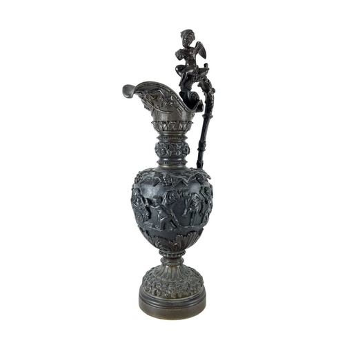 65 - A pair of substantial bronze side ewers. French, 19th century, the handles with cherub finials and r... 