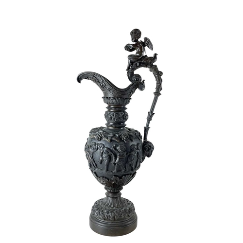 65 - A pair of substantial bronze side ewers. French, 19th century, the handles with cherub finials and r... 