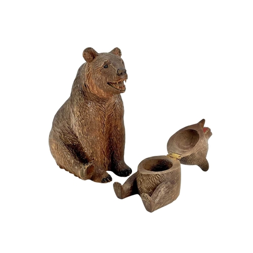 69 - A Black Forest carved bear inkwell. Early 20th century, height 7.5cm, together with a seated Black F... 