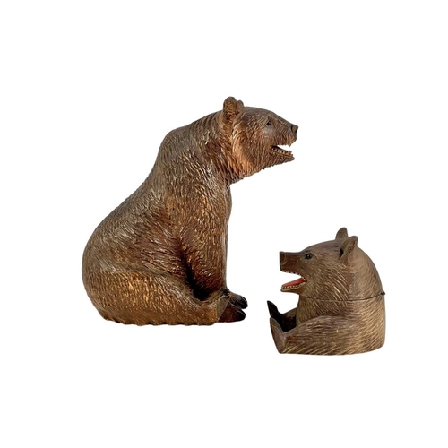 69 - A Black Forest carved bear inkwell. Early 20th century, height 7.5cm, together with a seated Black F... 