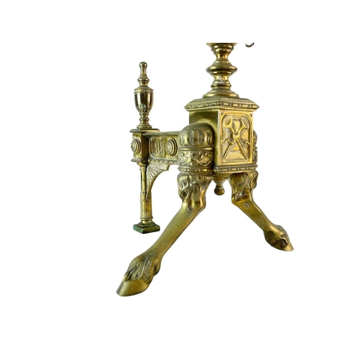 70 - A pair of ornate Neo-classical brass andirons. Early to mid 19th century, the urn finials with ring ... 