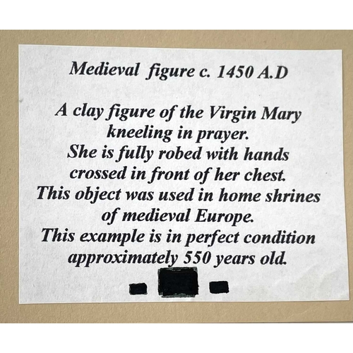 71 - A teracotta figure of the Virgin Mary. Probably medieval, kneeling in prayer, 8cm tall.