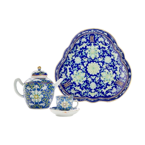 794 - A Chinese porcelain tea set. Comprising of tray, teapot cup and saucer, the tray measures 28cm wide.