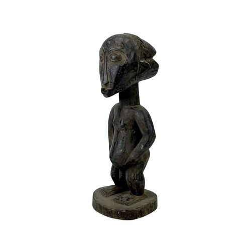 97 - A Luba figure of a man. Carved wood, height 35cm.