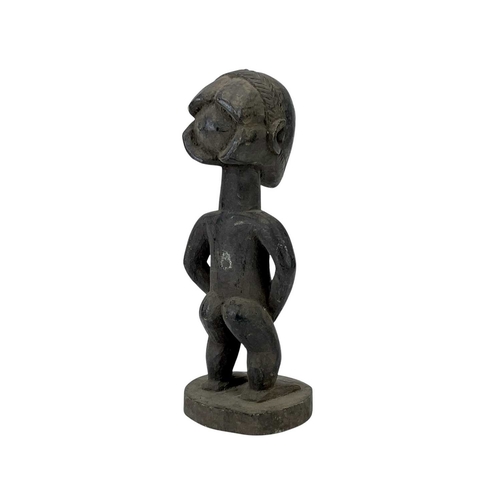 97 - A Luba figure of a man. Carved wood, height 35cm.