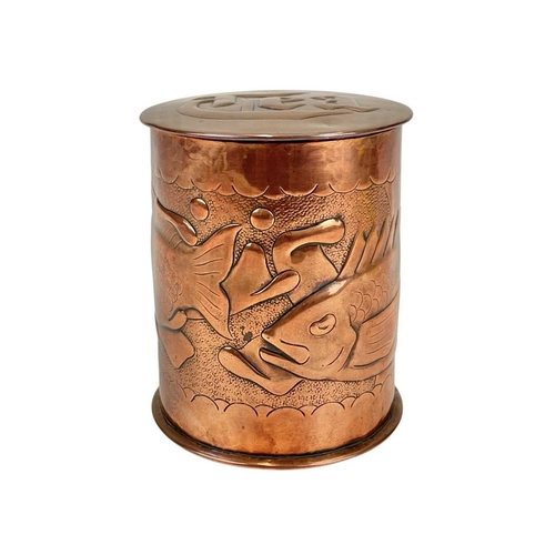 98 - A Newlyn cylindrical copper tea caddy Repousse decorated with two fish, on a matt ground, impressed ... 