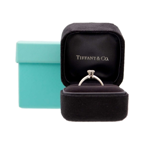 11 - TIFFANY & CO - A good platinum 0.59ct diamond solitaire ring with certificate and box. The six-claw ... 