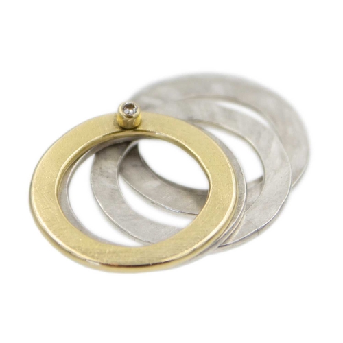 12 - A diamond set silver and yellow gold stacking ring in a box. Includes four silver and one gold flatt... 