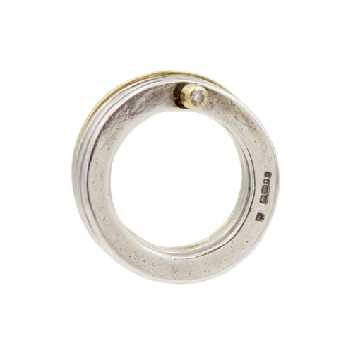 12 - A diamond set silver and yellow gold stacking ring in a box. Includes four silver and one gold flatt... 