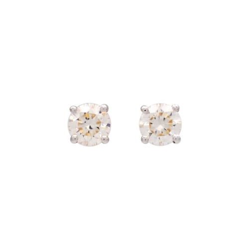 122 - A pair of 18k yellow gold diamond stud earrings. The clean white round brilliant-cut diamonds are 0.... 