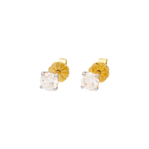 122 - A pair of 18k yellow gold diamond stud earrings. The clean white round brilliant-cut diamonds are 0.... 